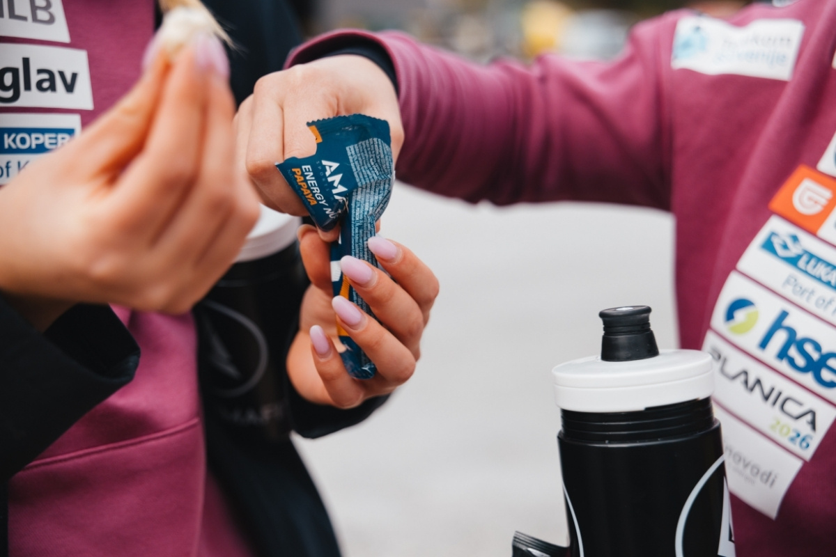 Closeup of two women eating protein snacks and a water bottle.